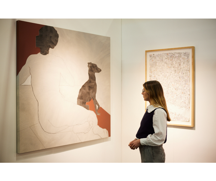 woman looking at artwork