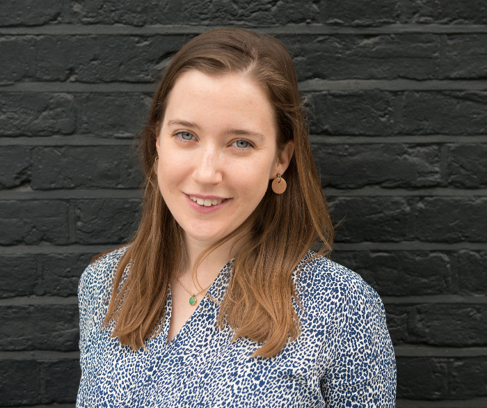 woman wearing blue and white blouse smiling