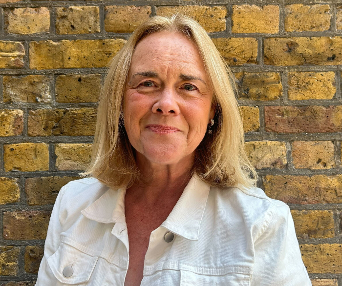 woman smiling, wearing white jacket