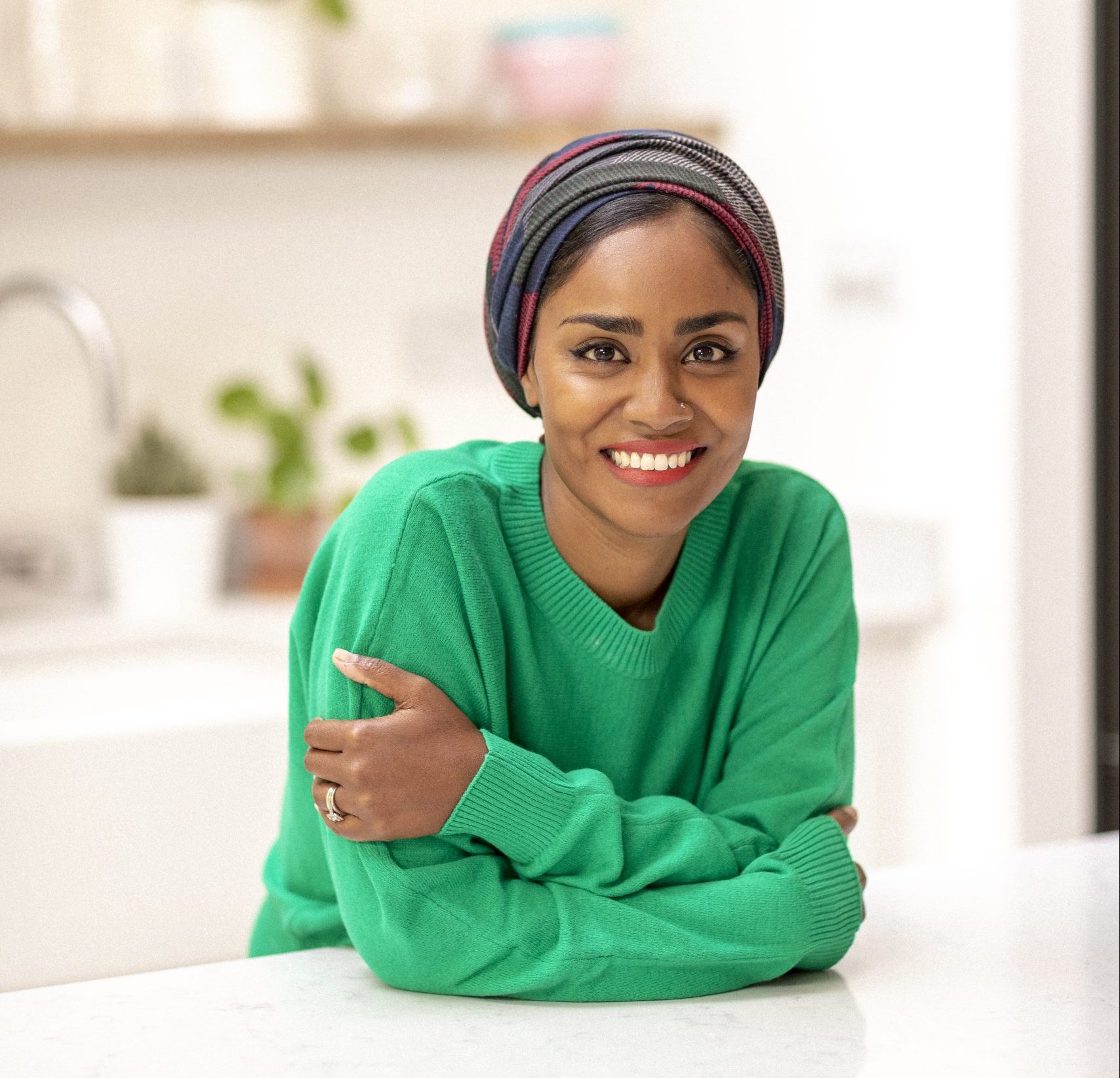 woman in green jumper smiling