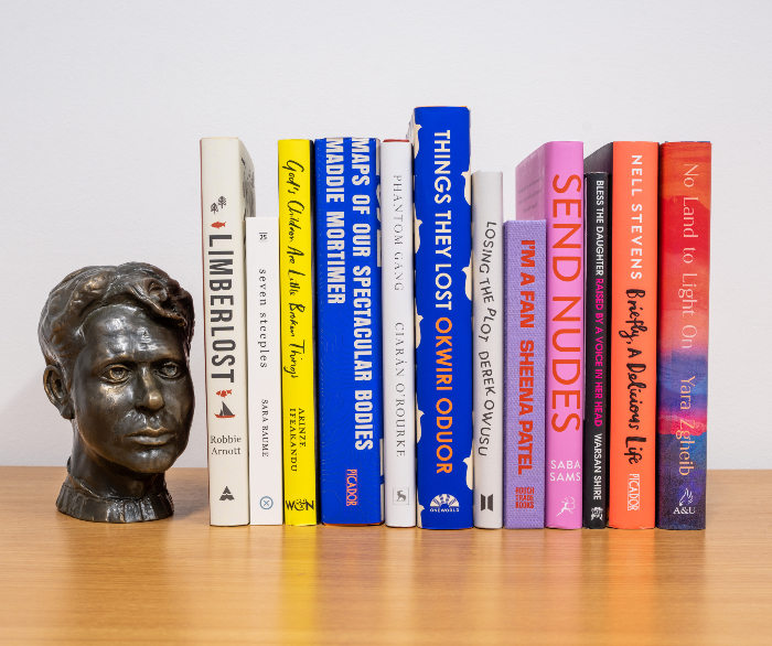 books lined up with sculpture of mans face