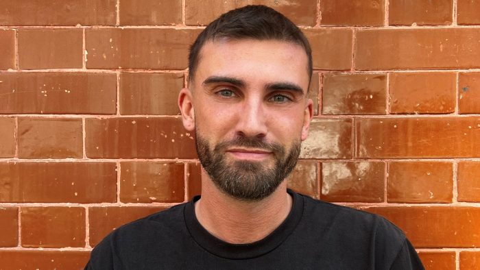 man smiling wearing black t-shirt