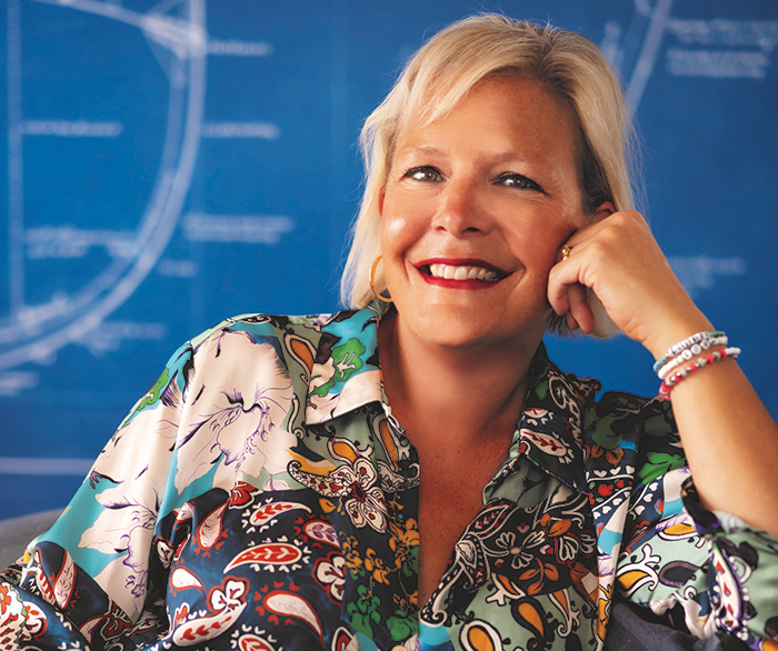 woman smiling and wearing multi-coloured blouse